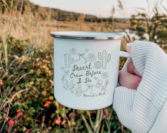 May include: White enamel camping mug with a green cactus design and the text "Desert Crew Before I Do Hannah's Bach".