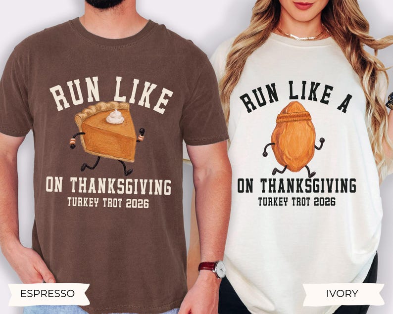 May include: A brown t-shirt with a graphic of a running pumpkin pie slice and the text RUN LIKE PIE ON THANKSGIVING TURKEY TROT 2026, and an ivory t-shirt with a running roasted turkey graphic and the text RUN LIKE A TURKEY ON THANKSGIVING TURKEY TROT 2026.