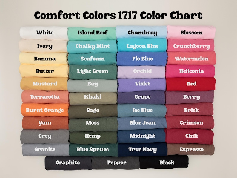May include: Color chart displaying a variety of Comfort Colors 1717 t-shirt colors. The chart includes shades like white, ivory, banana, and mustard, as well as greens, blues, pinks, and reds. The text "Comfort Colors 1717 Color Chart" is at the top.