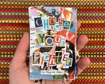 May include: A small, handmade book with a colorful paper cover. The title of the book is "Choose Your Fighter" and the author is "Zaynee Allen".