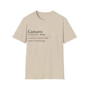 May include: A beige t-shirt with a black graphic that says "Camaro" and defines it as a "vicious creature that preys on mustangs."