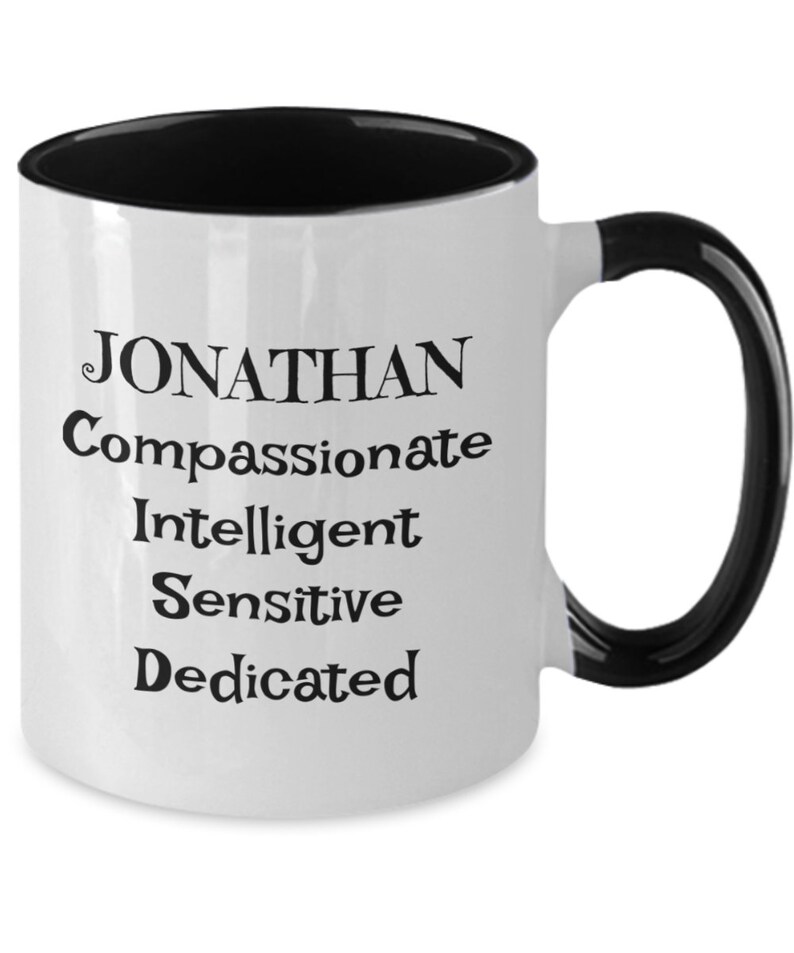 May include: White coffee mug with a black rim and handle. The mug has the name "JONATHAN" printed in black, followed by the words "Compassionate, Intelligent, Sensitive, Dedicated".