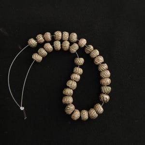 32 antique saharian silver small beads from southern morocco . Ancient silver beads.