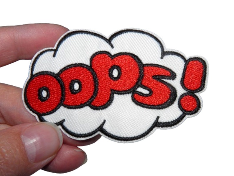 May include: Red embroidered iron-on patch with the word "OOPS!" in a white speech bubble.