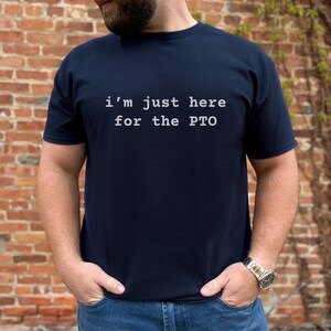 May include: A navy blue t-shirt with the text "i'm just here for the PTO" printed in white.