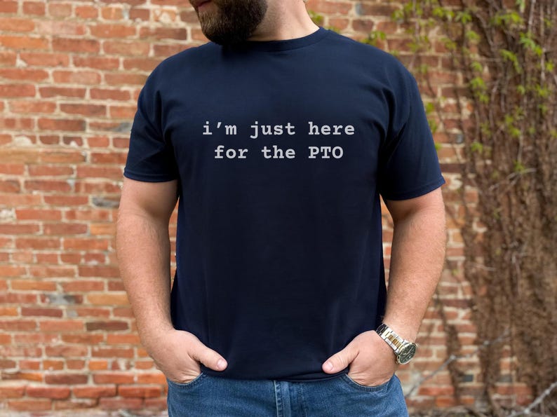May include: A navy blue t-shirt with the text "i'm just here for the PTO" printed in white.