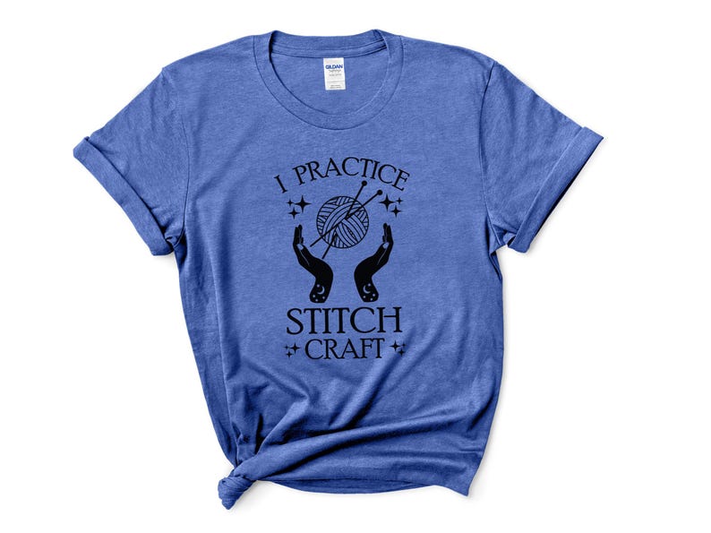 May include: A blue t-shirt with the text "I practice stitch craft" in black lettering. The design features a pair of hands holding a ball of yarn with knitting needles.