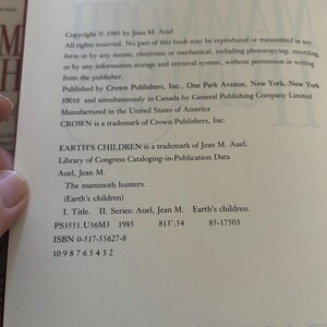 May include: A book page with copyright information from 1985 by Jean M. Auel. The text includes details about reproduction rights, the publisher, and a Library of Congress Cataloging-in-Publication Data entry for "The mammoth hunters."