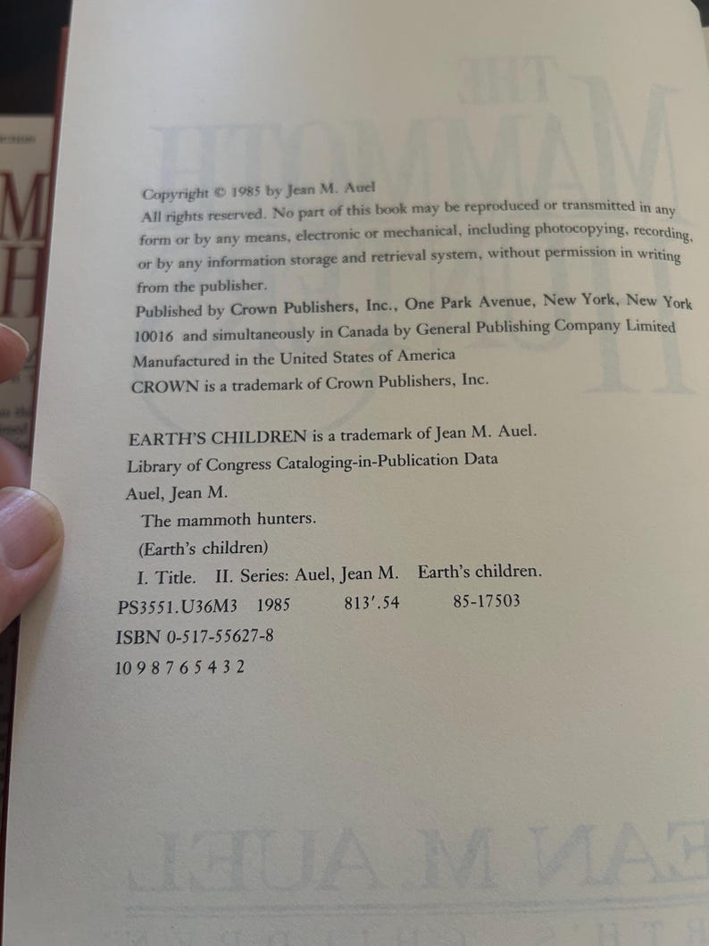 May include: A book page with copyright information from 1985 by Jean M. Auel. The text includes details about reproduction rights, the publisher, and a Library of Congress Cataloging-in-Publication Data entry for "The mammoth hunters."