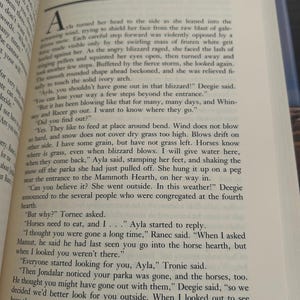 May include: Open book with text on a page. The page number 20 is visible at the top. The text is in black font on a cream-colored page. The book is open to a story.