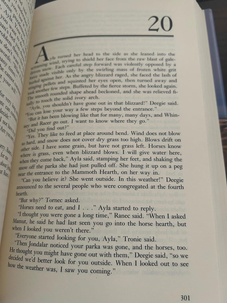 May include: Open book with text on a page. The page number 20 is visible at the top. The text is in black font on a cream-colored page. The book is open to a story.