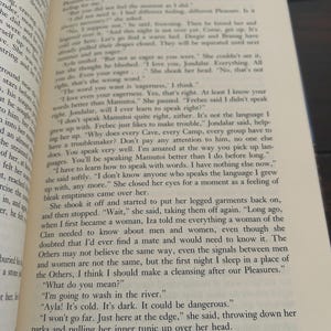 May include: Open book with text on the pages. The text is in English and appears to be a novel. The book is open to page 49.