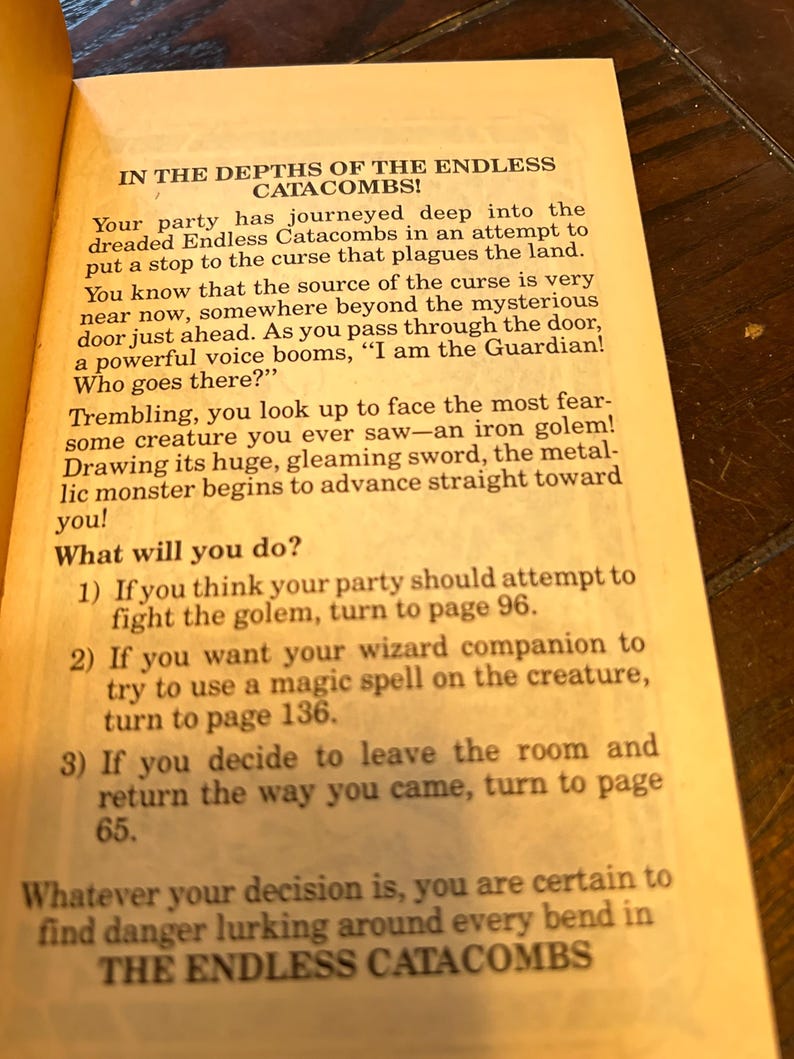 May include: Open book page with text: "IN THE DEPTHS OF THE ENDLESS CATACOMBS!" and instructions for the reader. The page has a yellowed, aged appearance. The text is in black font.