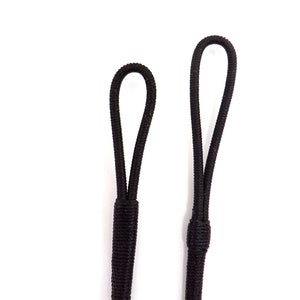 May include: Two black elastic loops with a single knot at the bottom of each loop.