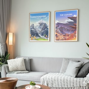 May include: Two framed posters with illustrations of landscapes from the video game Genshin Impact. The poster on the left is titled "Dragonspine" and depicts a snowy mountain range. The poster on the right is titled "The Chasm" and depicts a rocky canyon with a waterfall.
