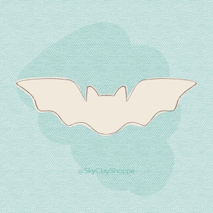 May include: A white bat silhouette on a light blue background with the text "@SkyClayShoppe" at the bottom.