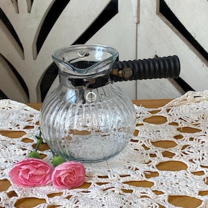 May include: A set of three ceramic mugs with a speckled, matte finish. The mugs are in shades of cream, light gray, and dark gray. Each mug has a simple, minimalist design, perfect for coffee or tea.