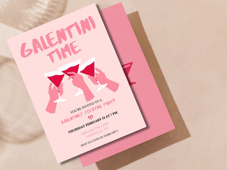 May include: Pink invitation card with the text "Galentini Time" in black lettering. The card features a graphic of three hands holding up pink martini glasses. The text below the graphic reads "You're invited to a Galentines Cocktail Party" with a pink heart symbol. The date, time, and location of the party are listed below the text.