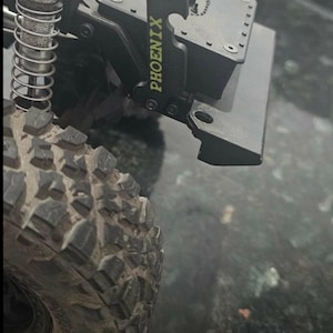 May include: A set of three ceramic mugs with a speckled, cream-colored glaze. Each mug features a different hand-painted floral design in shades of blue, green, and yellow. The mugs have a simple, rounded shape and a comfortable handle.