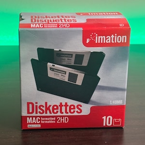 May include: A box of Imation brand 2HD Mac formatted diskettes. The box is red and white with the word "Diskettes" in large red letters. The box contains 10 diskettes, each with a 1.40MB capacity.