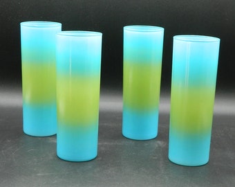 May include: Four frosted glass tumblers with a gradient design. The glasses are blue at the top, green in the middle, and blue at the bottom.