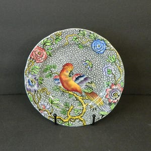 May include: A white ceramic mug with a black handle and the text "But First, Coffee" in a handwritten style. The mug is on a white surface. The mug is approximately 4 inches tall.