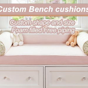 May include: Custom bench cushions with foam filling and free piping. The cushions are pink and have a floral pattern. The bench is white with two drawers.