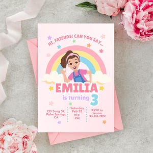 Pastel-themed birthday invitation featuring a cartoon girl inspired by Ms. Rachel, waving with a cheerful expression. The design includes a rainbow, clouds, and colorful stars on a light pink background. The text reads, 'Hi, friends! Can you say…' followed by 'Emilia is turning 3' in bold pink and purple letters. Below, event details such as date, time, location, and RSVP contact are displayed in a playful font. Simply edit, save, and print or share digitally!