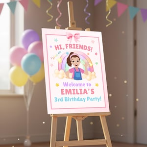 May include: A pink birthday party sign on a wooden easel. The sign reads "Hi, Friends!" and "Welcome to EMILIA'S 3rd Birthday Party!" A cartoon girl is featured with a rainbow and stars. Balloons and party decorations are in the background.