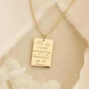 May include: Gold necklace with a rectangular pendant that reads "He has made everything beautiful in its time."