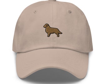 May include: A beige baseball cap with an embroidered brown golden retriever silhouette.