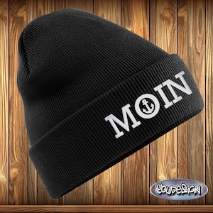 May include: Black beanie with a white embroidered anchor and the word "MOIN" on the front.