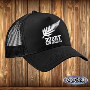 May include: Black trucker hat with a white embroidered fern leaf and the text "Rugby New Zealand".