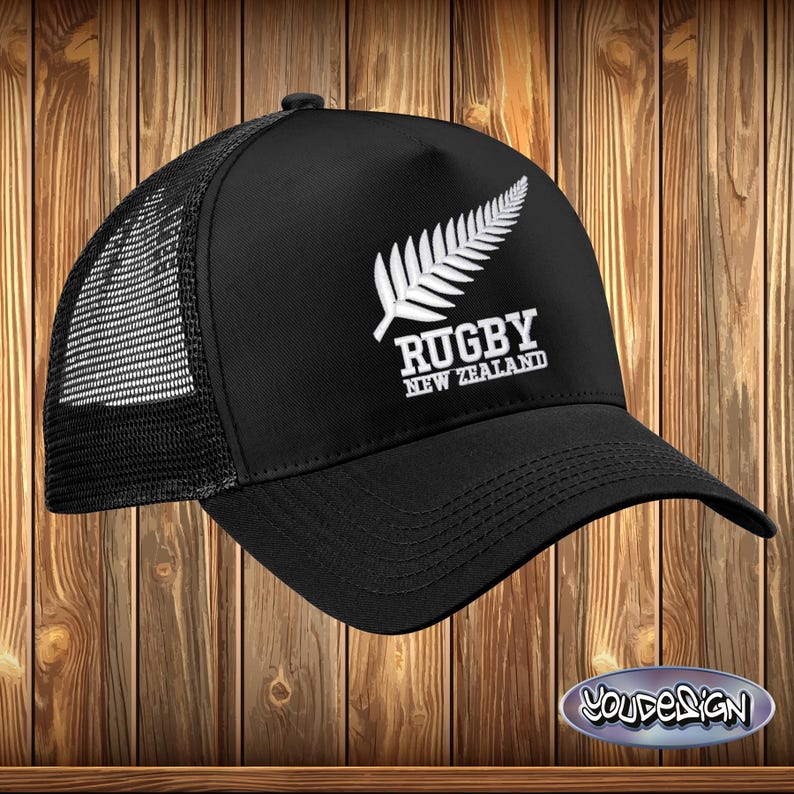 May include: Black trucker hat with a white embroidered fern leaf and the text "Rugby New Zealand".