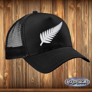 May include: Black trucker hat with a white embroidered silver fern leaf design.