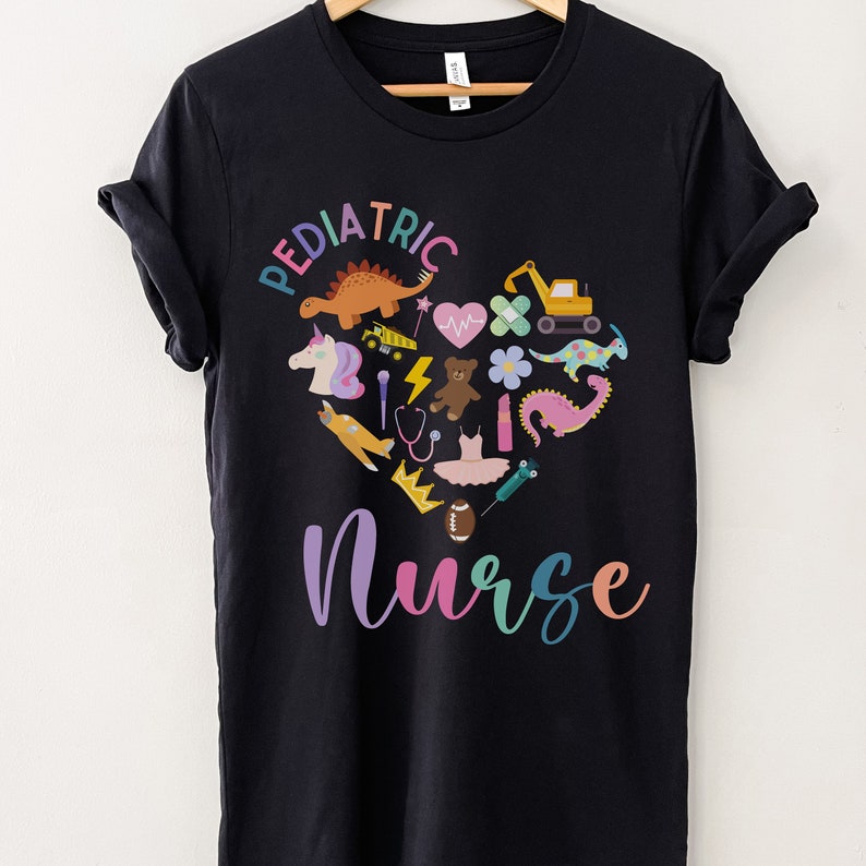 May include: Black t-shirt with a colourful heart design featuring various children's toys and the text "Pediatric Nurse".