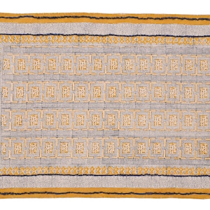 May include: A yellow and gray patterned rug with a geometric design. The rug has a fringe border.