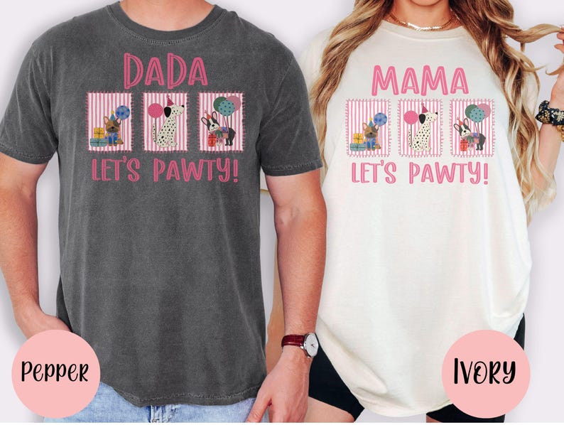 May include: Two t-shirts, one pepper-colored and one ivory-colored, each with a pink graphic. The pepper shirt says "DADA LET'S PAWTY!" and the ivory shirt says "MAMA LET'S PAWTY!". Each shirt features three dog illustrations.