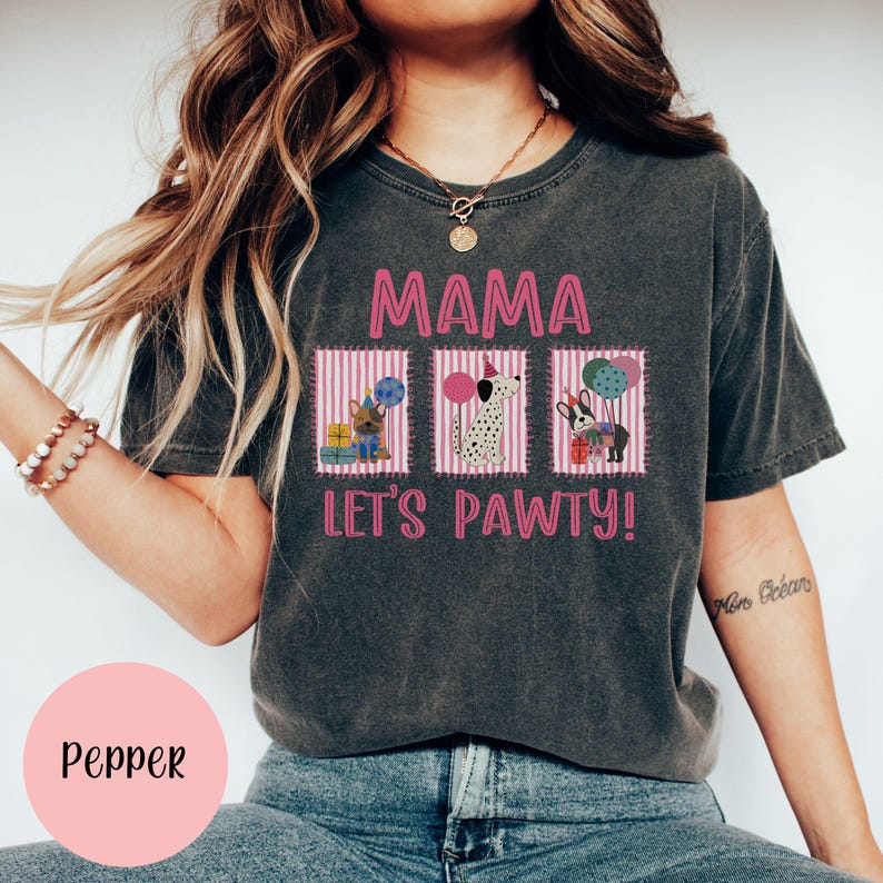 May include: Dark gray t-shirt with the text "MAMA LET'S PAWTY!" in pink. The shirt features three pink striped boxes with illustrations of dogs holding balloons and gifts. The word "Pepper" is in a pink circle.