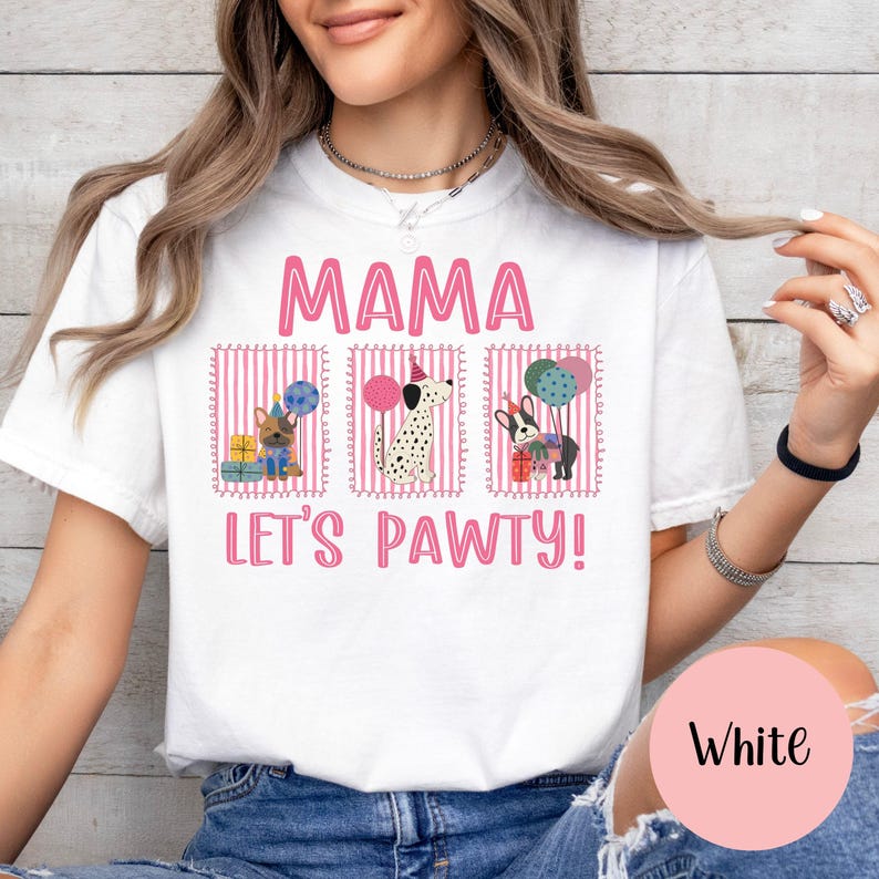 May include: White t-shirt with the pink text "MAMA" above the phrase "LET'S PAWTY!" and three dog illustrations. The illustrations include a French Bulldog, a Dalmatian, and a German Shepherd, each with party accessories.