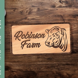 May include: A wooden sign with the text "Robinson Farm" and a black and white illustration of a cow's head.