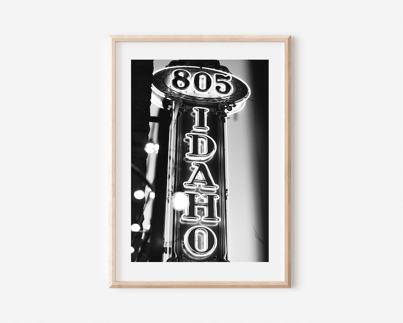 May include: Black and white photograph of a neon sign that reads "805 IDAHO" in a vintage style.