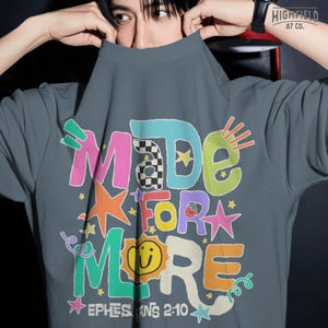 Christian shirt PNG featuring colorful doodle typography with Ephesians 2:10 scripture and positive faith message.