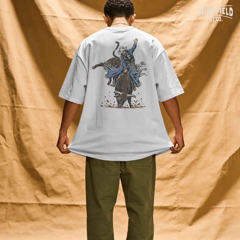 Bull rider PNG featuring a cowboy in motion on a bucking rodeo bull with rough dirt details, made for rodeo fans and cowboy shirt designs.