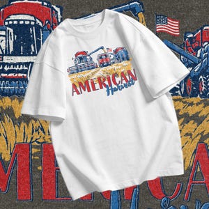 Patriotic Farmer PNG showing combine harvester, tractor, grain truck, wheat field, and American Harvest lettering for farm life apparel designs.