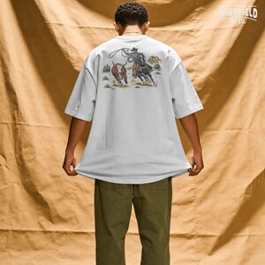 Cowboy gift PNG showing a team roping scene with horse, steer, lasso, desert shrubs, and classic western ranch details.