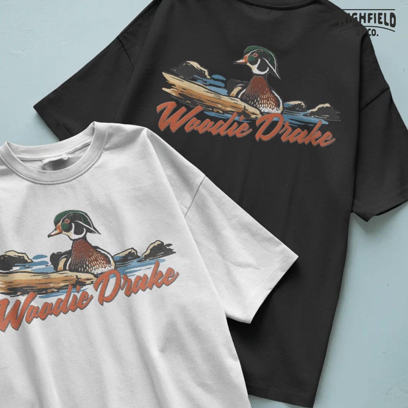 Waterfowl hunting PNG featuring a wood duck drake in natural water surroundings, Woodie Drake graphic for apparel