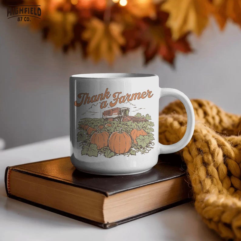Vintage farm PNG featuring a pumpkin patch scene with orange pumpkins, leafy vines, rolling fields, and a combine harvester under the words “Thank a Farmer.”