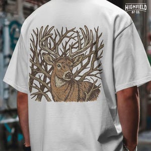 Deer hunting png design featuring a whitetail buck surrounded by forest branches