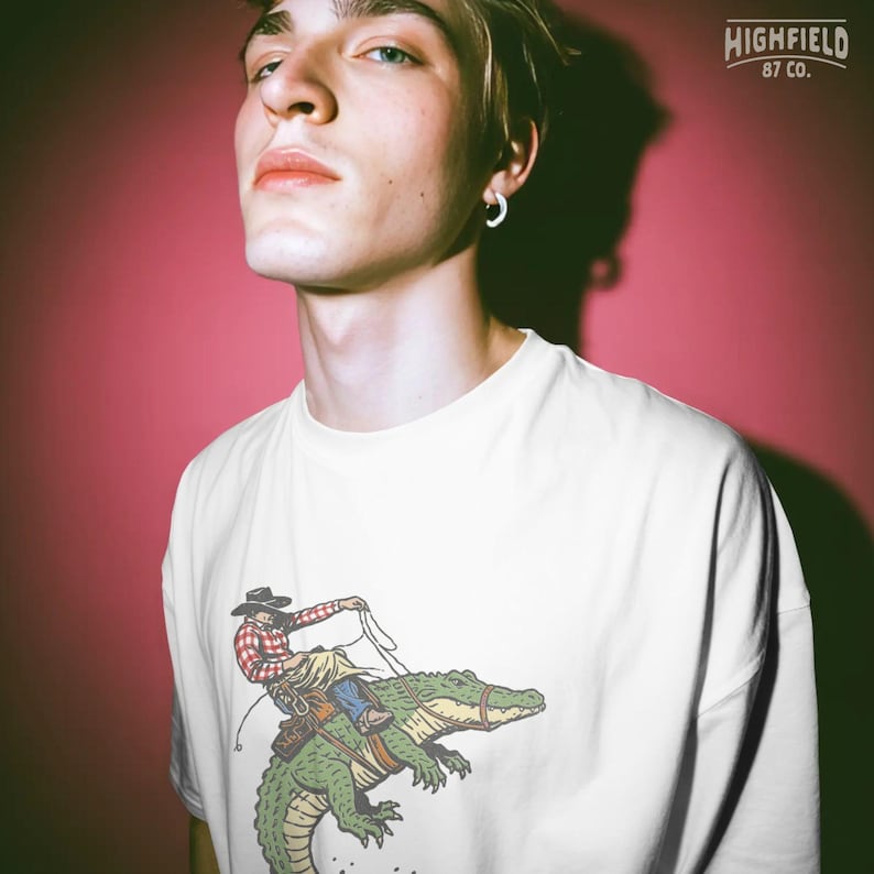 Funny western PNG with cowboy riding alligator and rope in bold vintage illustration style